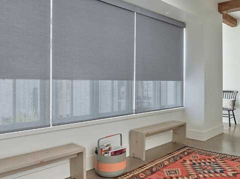 Hallway interior with 3 large windows covered by shades